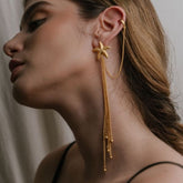 Model wearing Mirella earrings with loose waves and soft beach styling